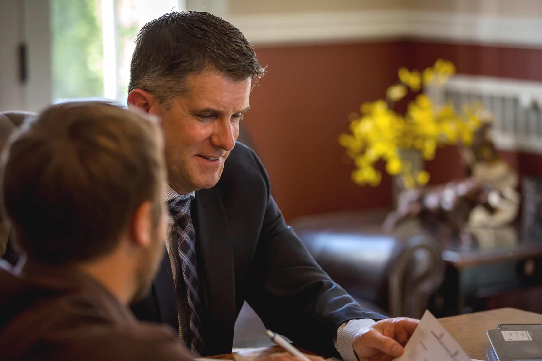Attorney Chris Bugbee discussing documents with a client
